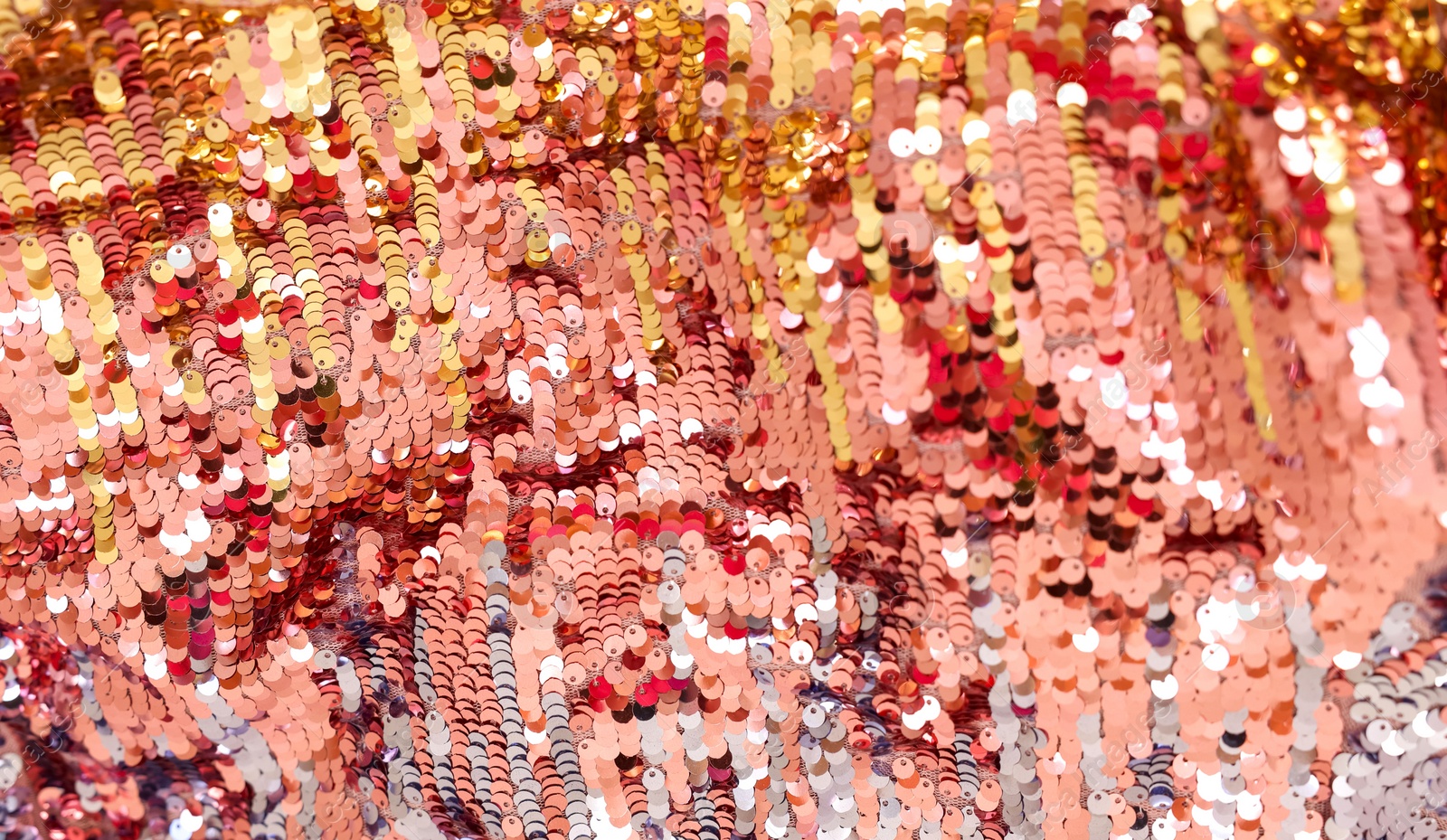 Photo of Texture of stylish pink carnival dress with sequins as background, top view