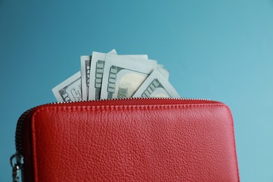 One stylish leather purse on light blue background, closeup