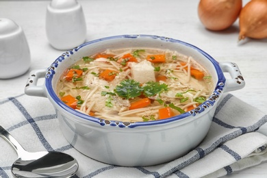 Photo of Dish with fresh homemade chicken soup served on table