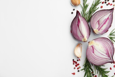 Fresh red onions, garlic, rosemary and spices on white background, flat lay. Space for text