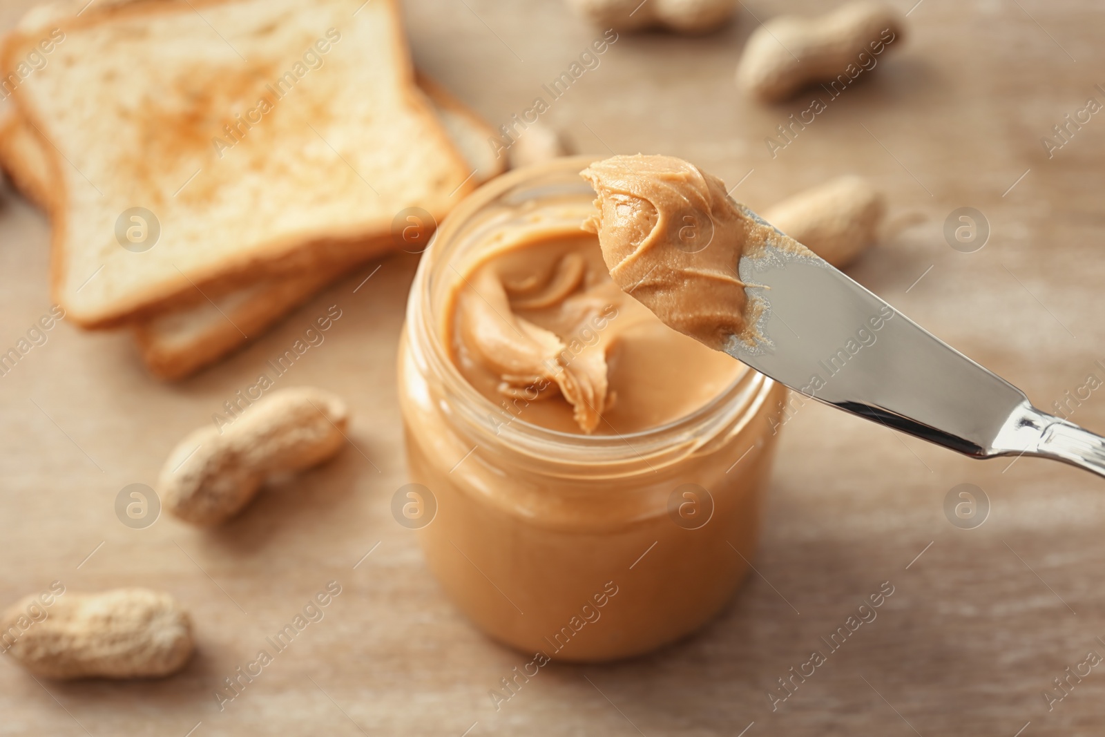 Photo of Knife with creamy peanut butter, closeup