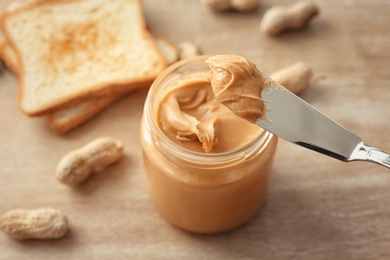 Photo of Knife with creamy peanut butter, closeup