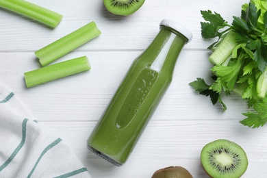 Photo of Flat lay composition with bottle of fresh celery juice on white wooden table