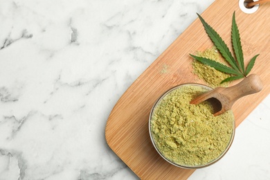 Photo of Flat lay composition with bowl of hemp protein powder on marble table. Space for text