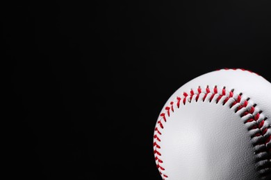 Photo of Baseball ball on black background, closeup. Space for text