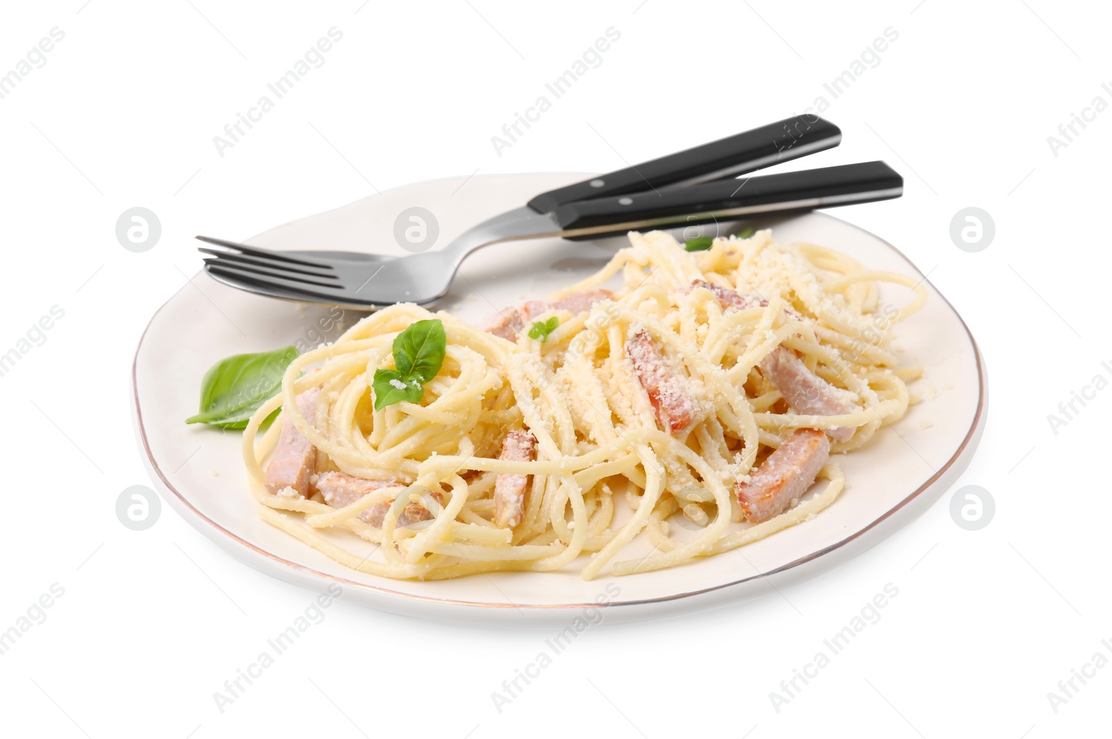 Photo of Plate of tasty pasta Carbonara with basil leaves isolated on white