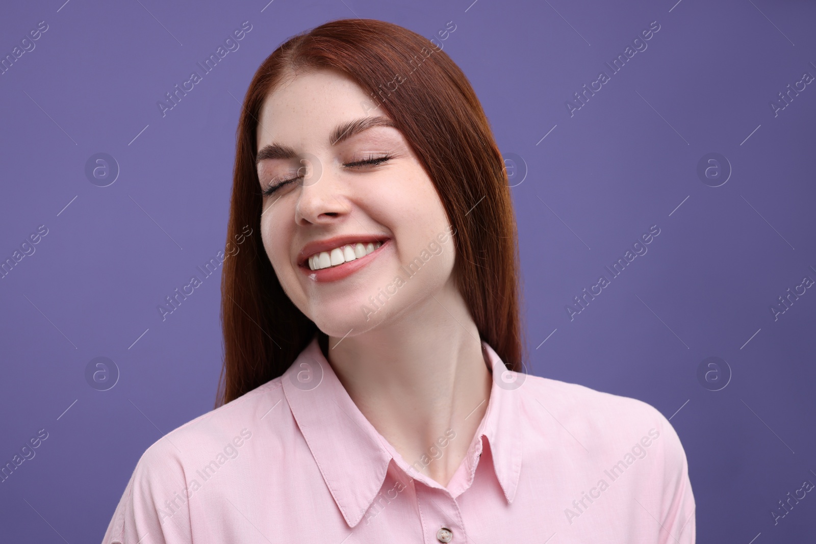 Photo of Portrait of smiling woman with freckles on purple background