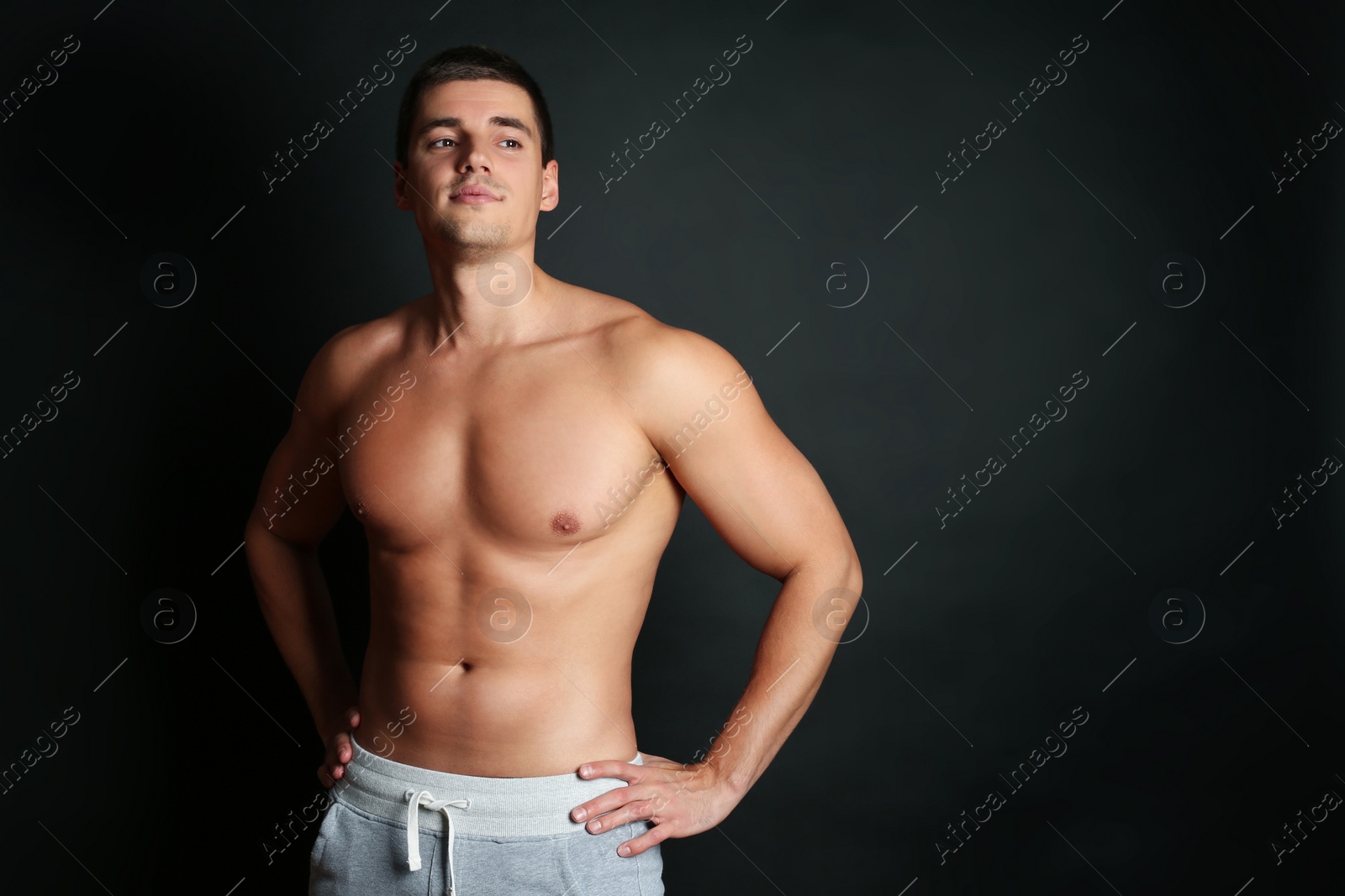 Photo of Man with sexy body on black background