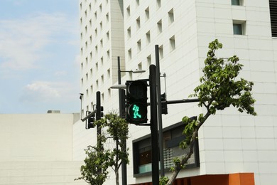 Photo of Traffic light for pedestrians on city street. Road rules