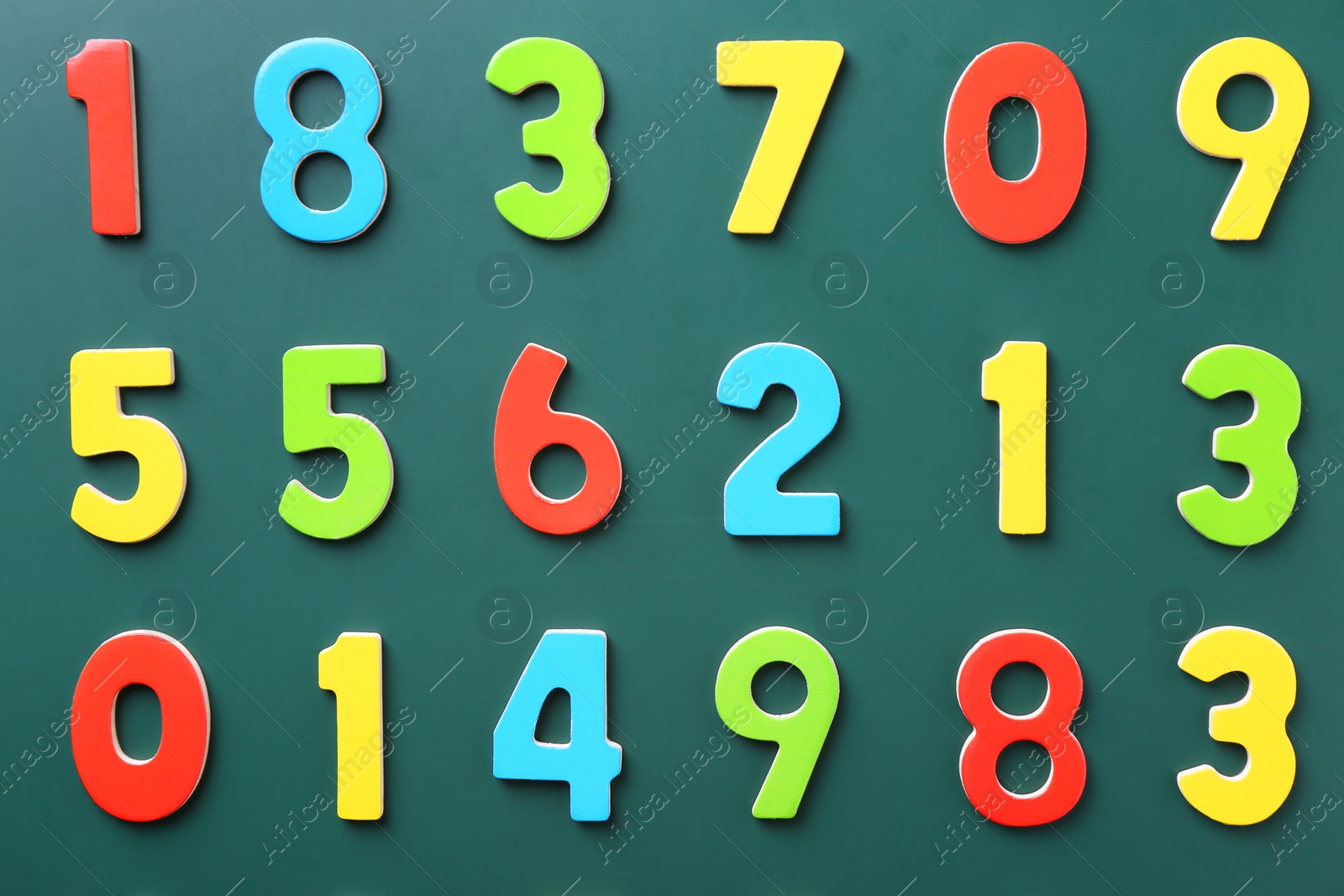 Photo of Colorful numbers on green background, flat lay