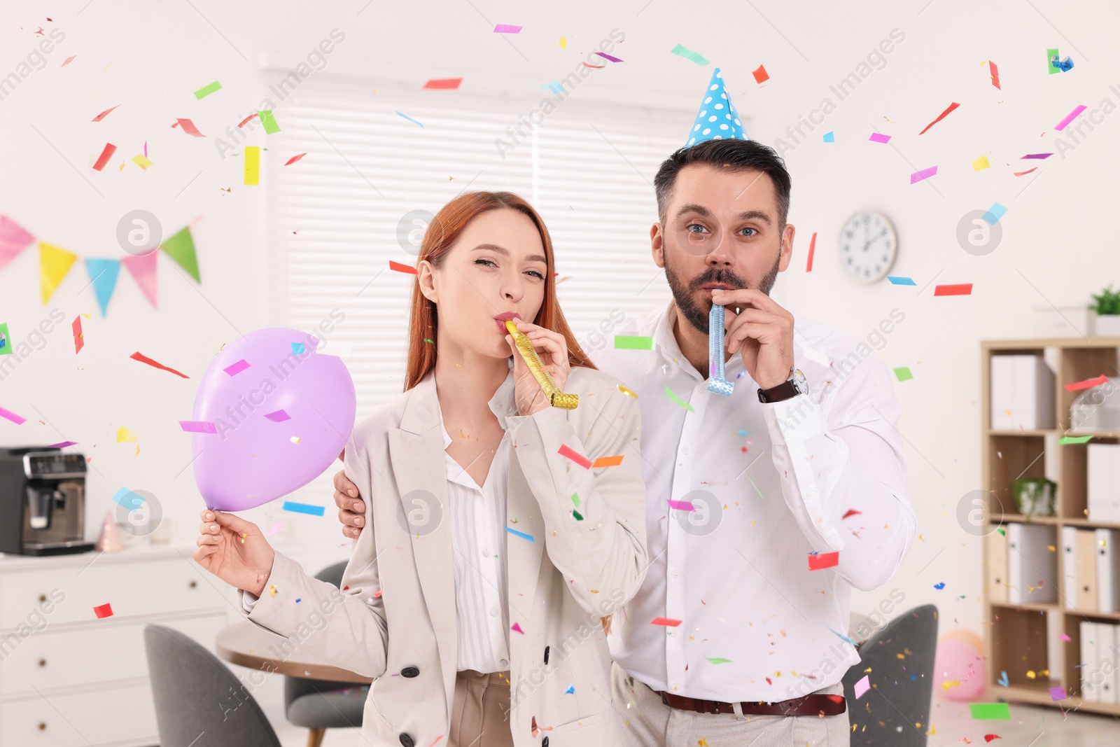 Photo of Coworkers having fun during office party indoors