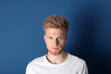 Portrait of handsome young man on blue background