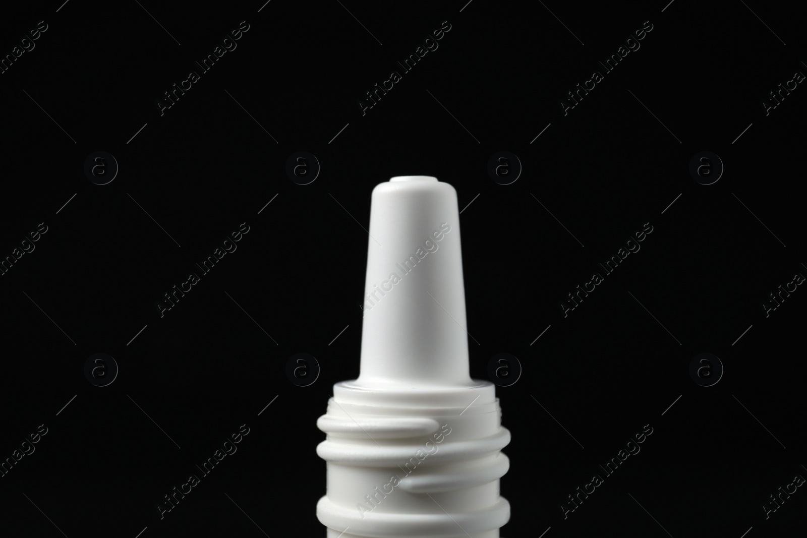 Photo of Bottle of nasal spray on black background, closeup