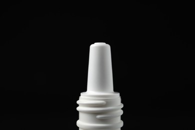 Bottle of nasal spray on black background, closeup