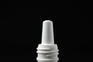 Photo of Bottle of nasal spray on black background, closeup