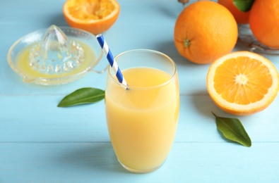 Photo of Composition with orange juice and fresh fruit on wooden background