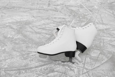 Pair of figure skates on ice, space for text