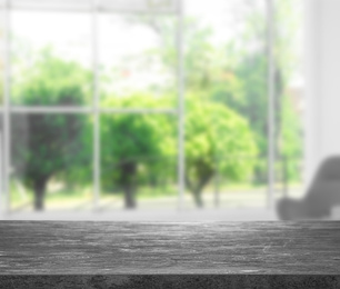 Empty grey stone surface and blurred view of modern window 