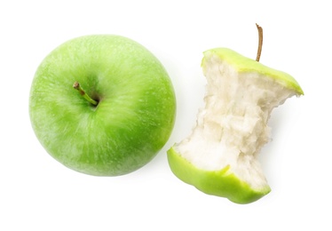 Half-eaten and whole green apple isolated on white