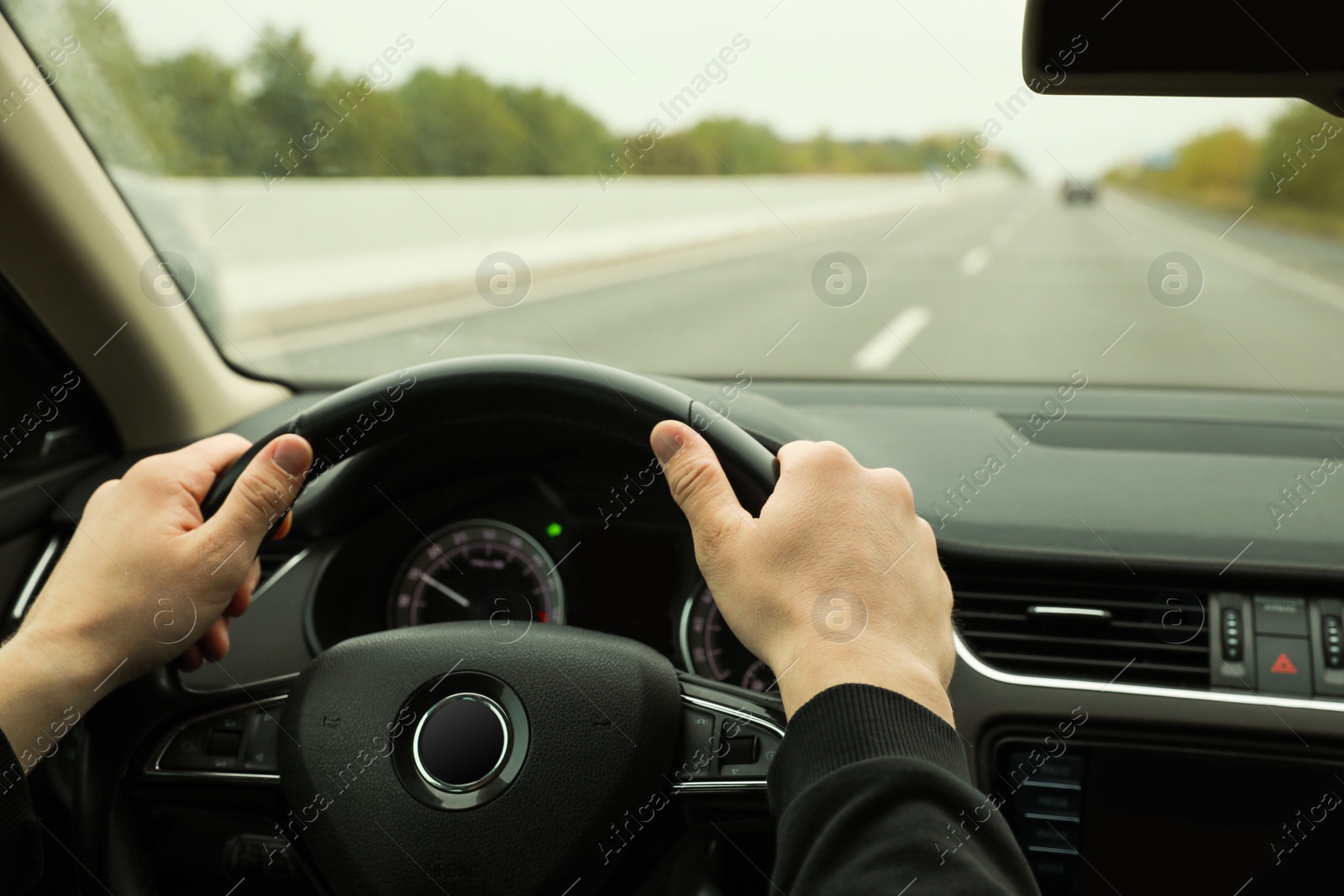 Photo of Man driving his car, closeup. Traffic rules