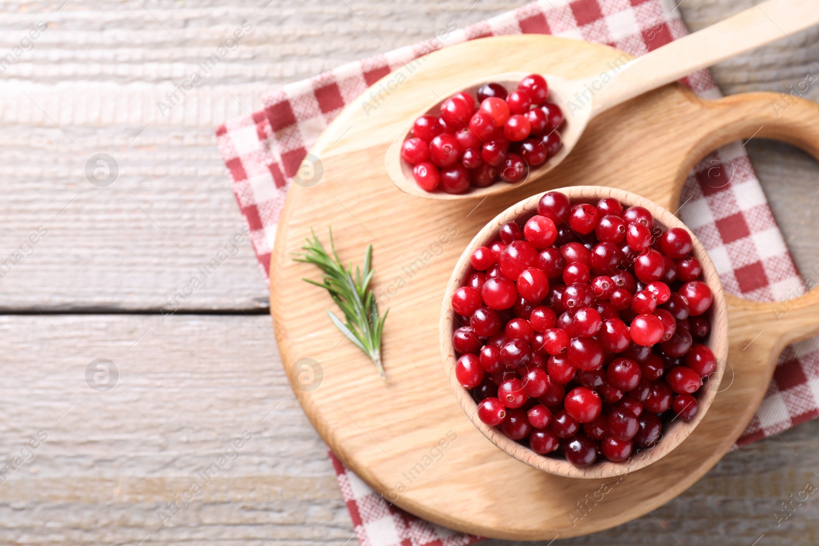 Photo of Fresh ripe cranberries on wooden table, top view