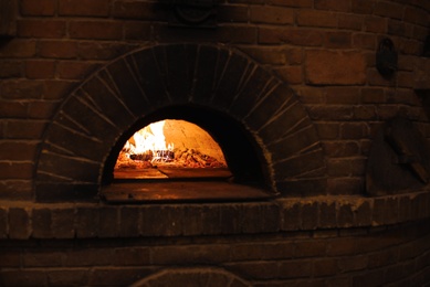 Photo of Traditional brick oven for baking pizza indoors