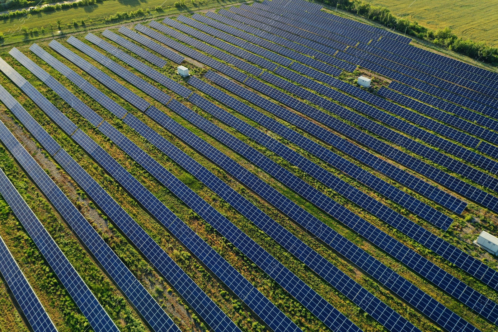 Photo of Solar panels installed outdoors, aerial view. Alternative energy source