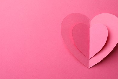 Photo of Paper hearts on pink background, top view. Space for text