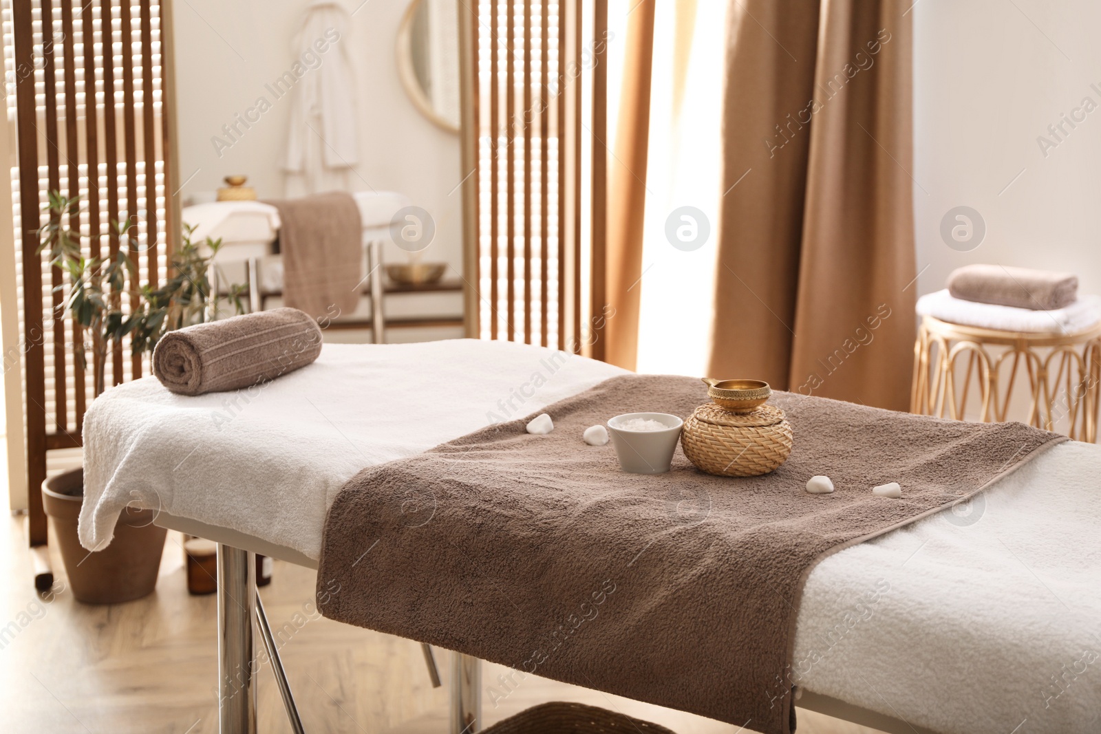 Photo of Stylish room interior with massage table in spa salon