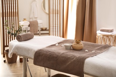 Photo of Stylish room interior with massage table in spa salon