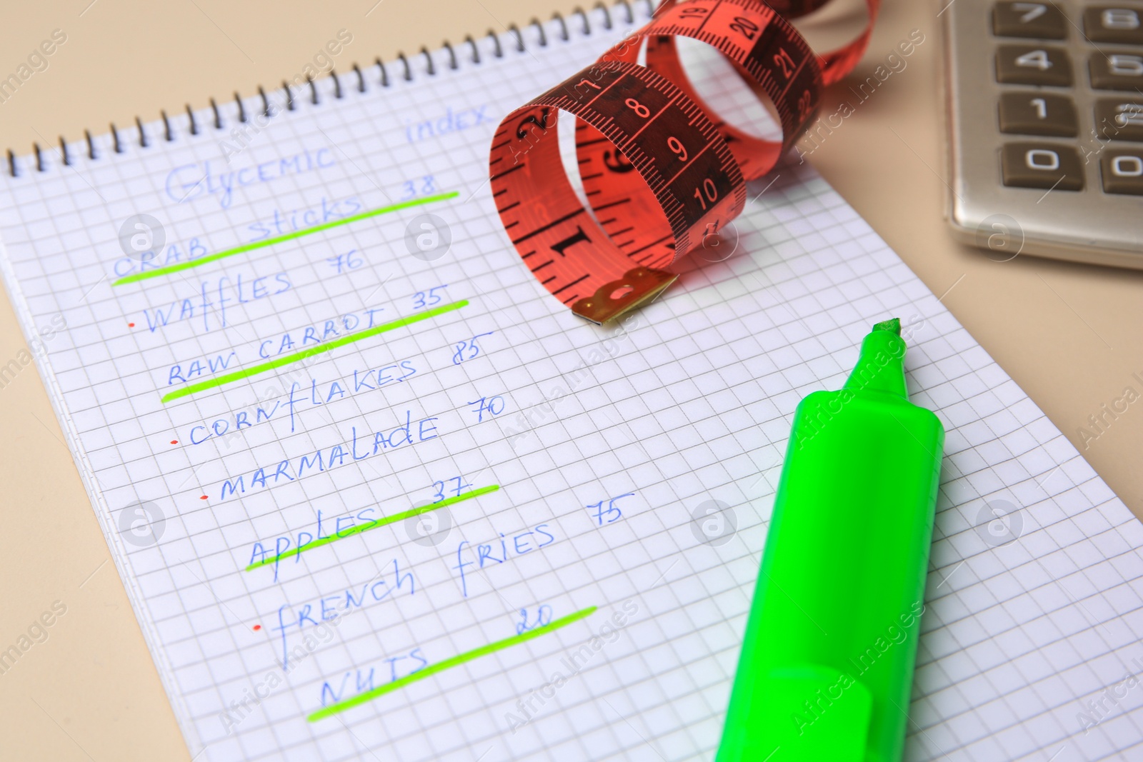 Photo of Glycemic index. Notebook with information, measuring tape, marker and calculator on beige background, closeup