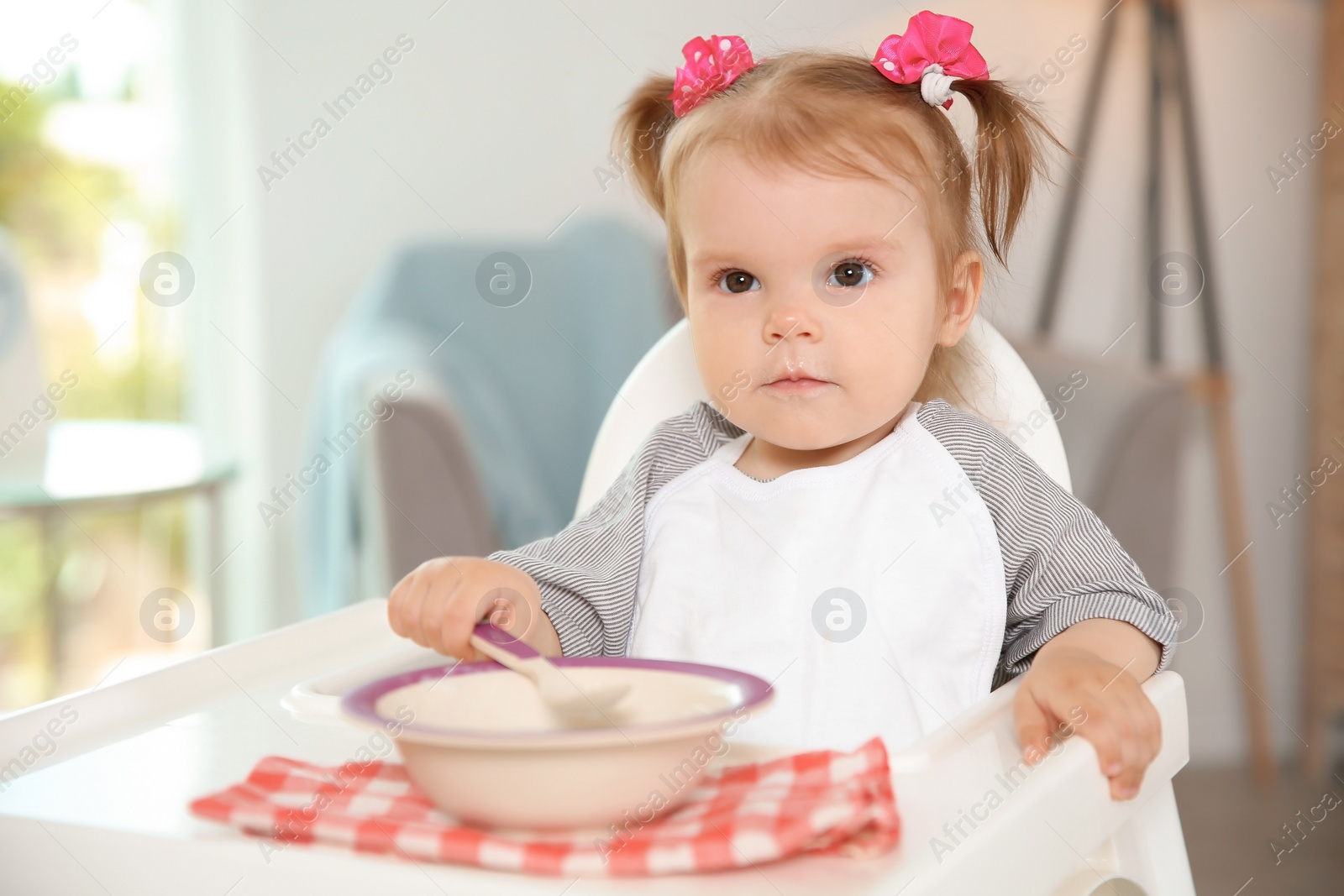 Photo of Cute little girl eating healthy food at home