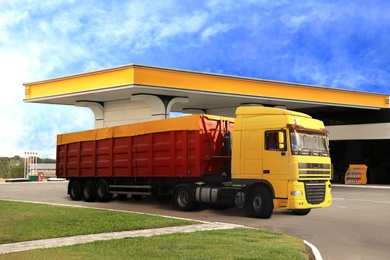 Image of Bright truck driving from modern gas filling station