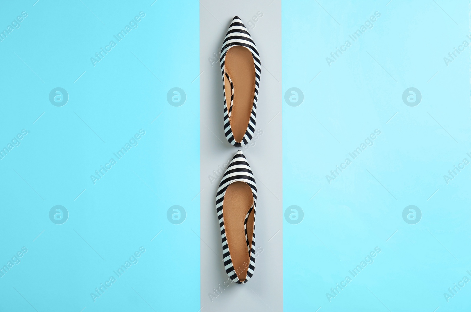 Photo of Pair of female shoes on color background, top view