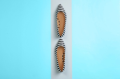 Photo of Pair of female shoes on color background, top view