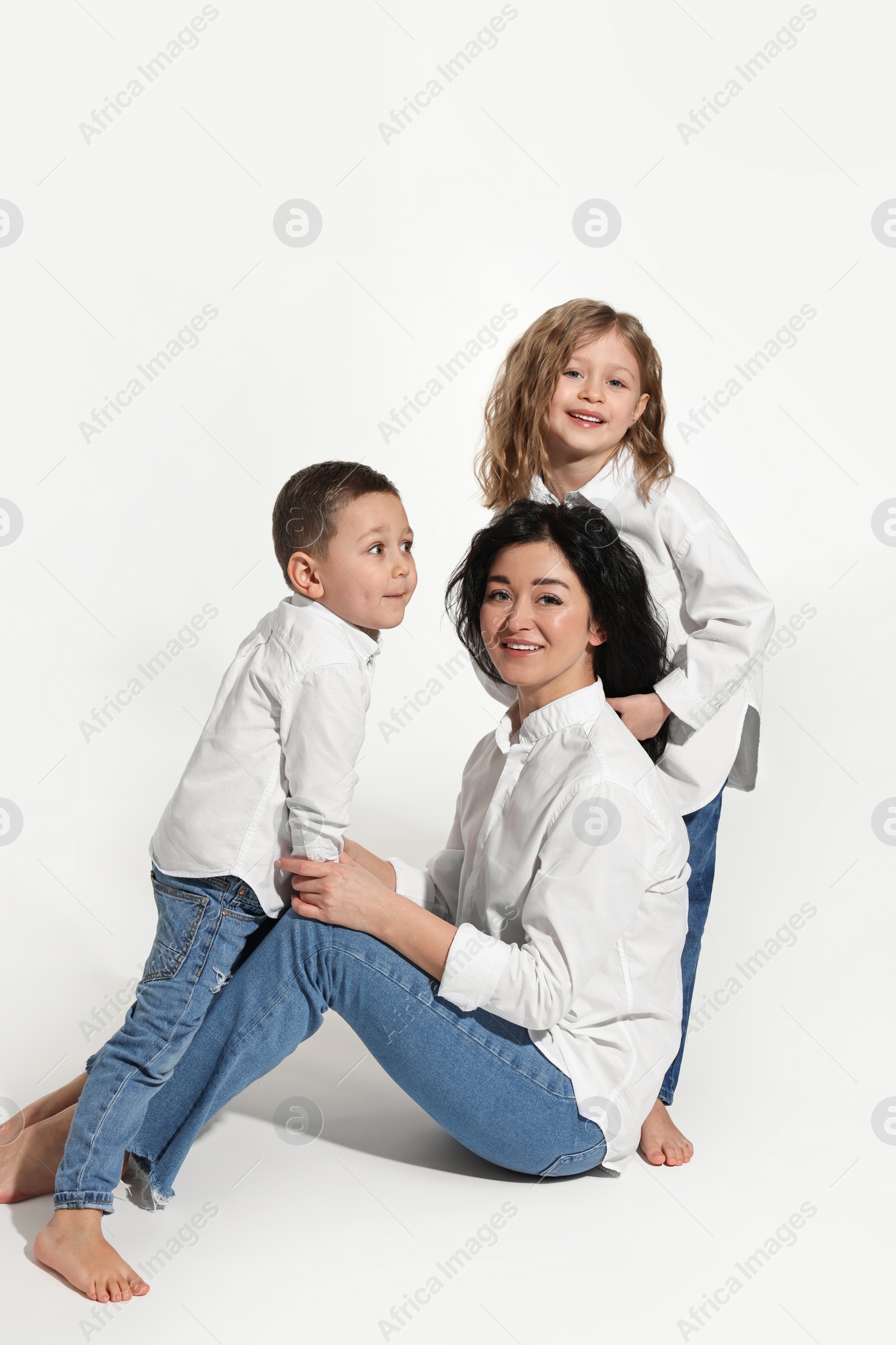 Photo of Little children with their mother on white background