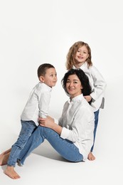 Little children with their mother on white background