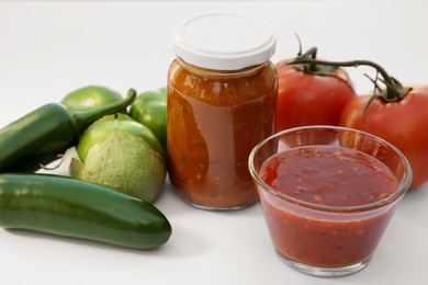 Photo of Delicious salsa sauce and ingredients on white background, closeup