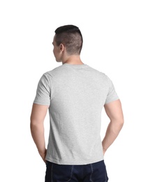 Young man in grey t-shirt on white background. Mockup for design