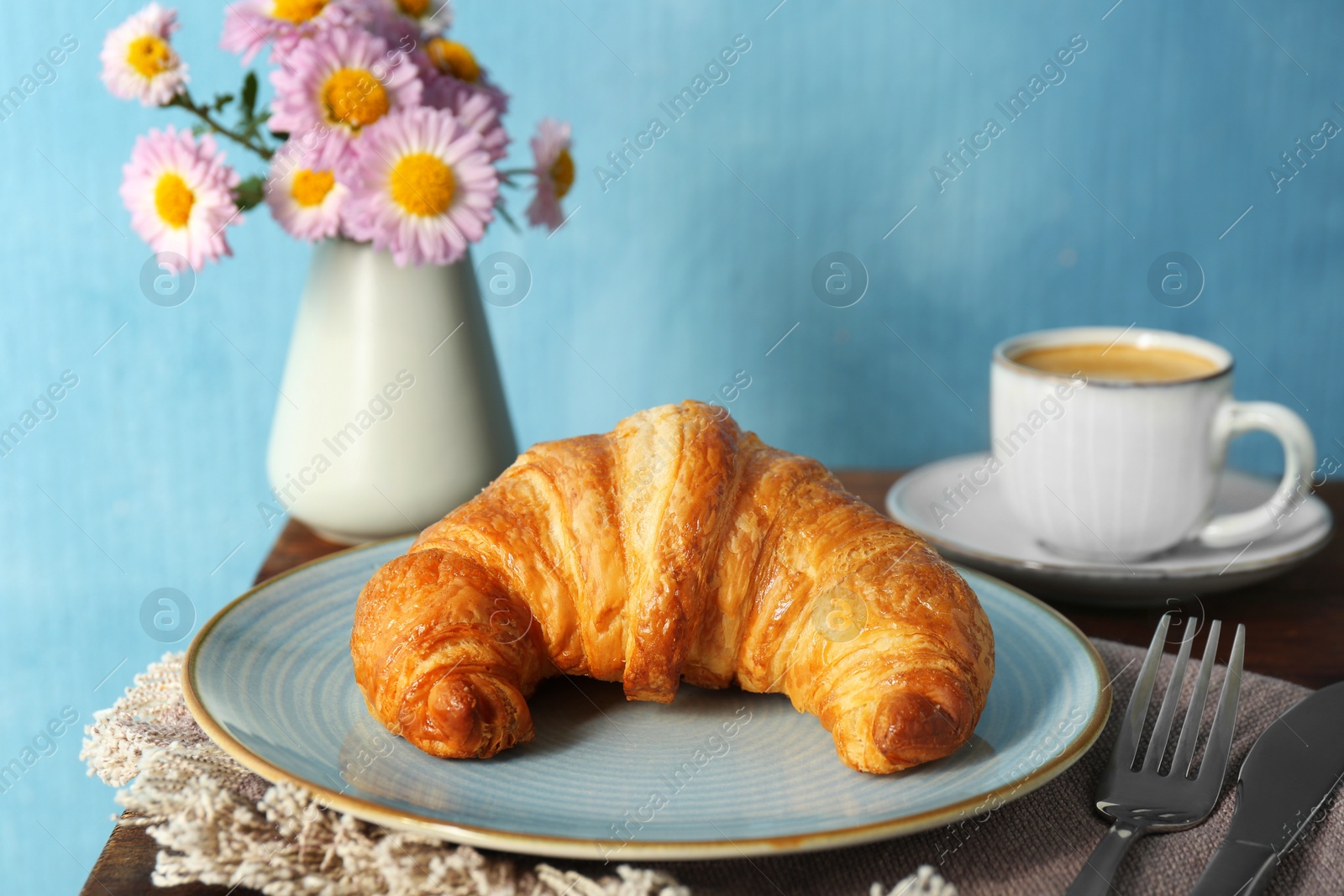 Photo of Delicious fresh croissant served with coffee on table, closeup