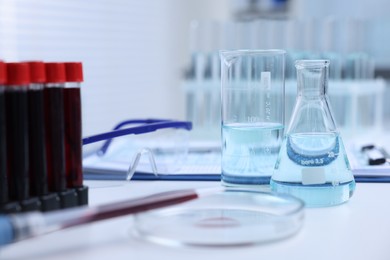Laboratory glassware with samples on table indoors