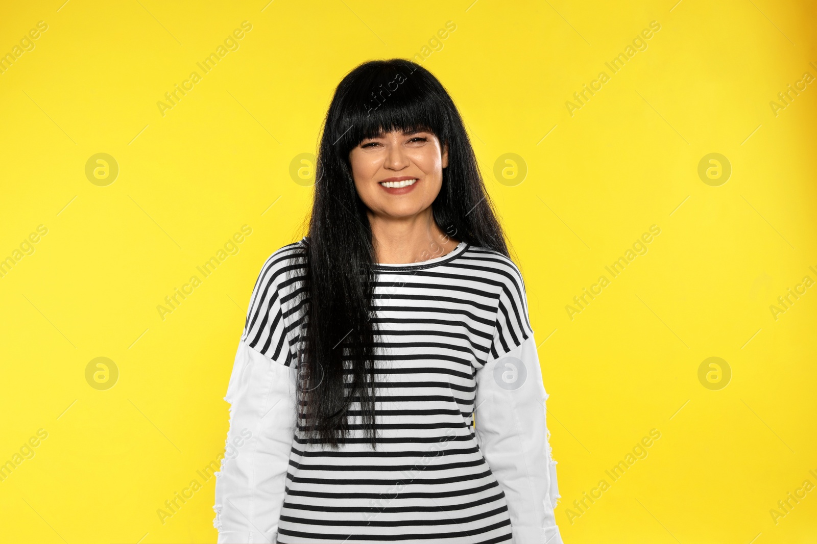 Photo of Portrait of beautiful mature woman on color background