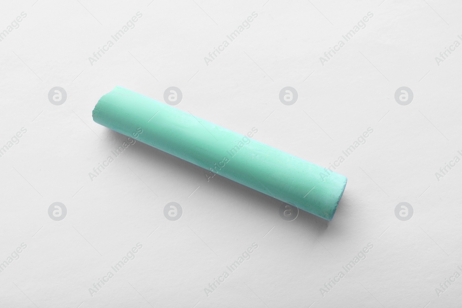 Photo of Piece of green chalk isolated on white, top view