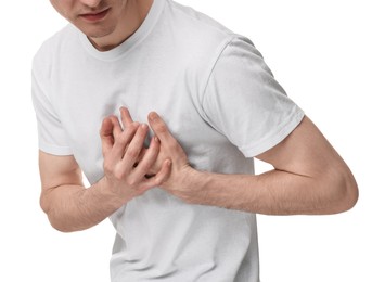 Man suffering from heart hurt on white background, closeup