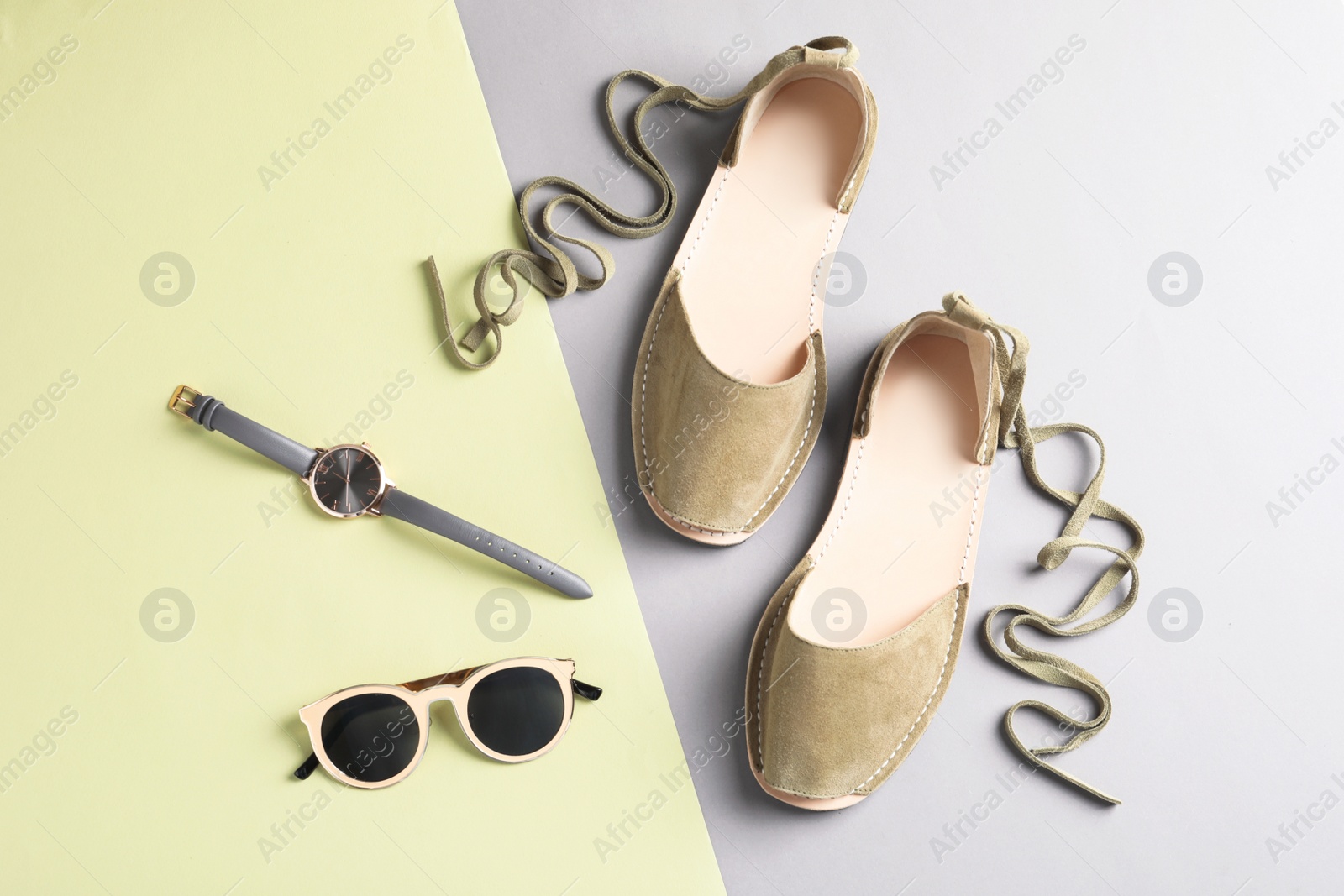 Photo of Pair of trendy women's shoes and accessories on color background