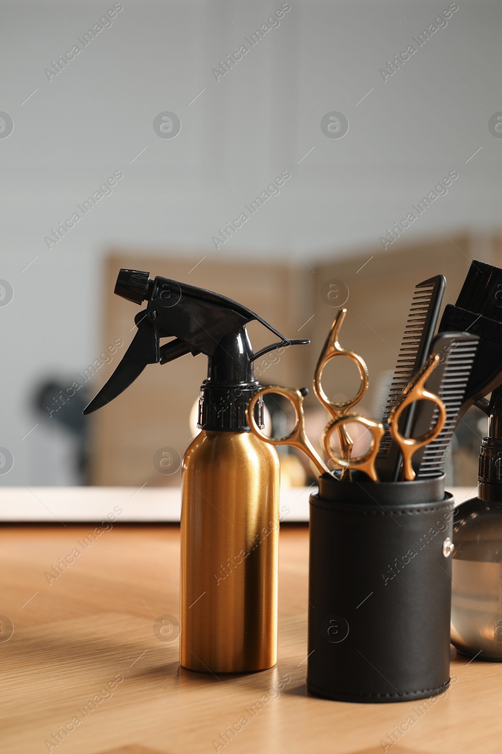 Photo of Set of hairdresser tools on table in salon