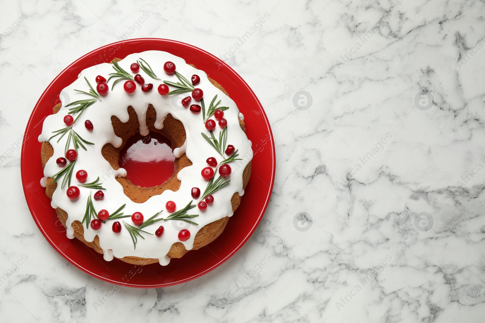 Photo of Traditional homemade Christmas cake on white marble table, top view. Space for text