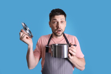 Disappointed man with pot on light blue background