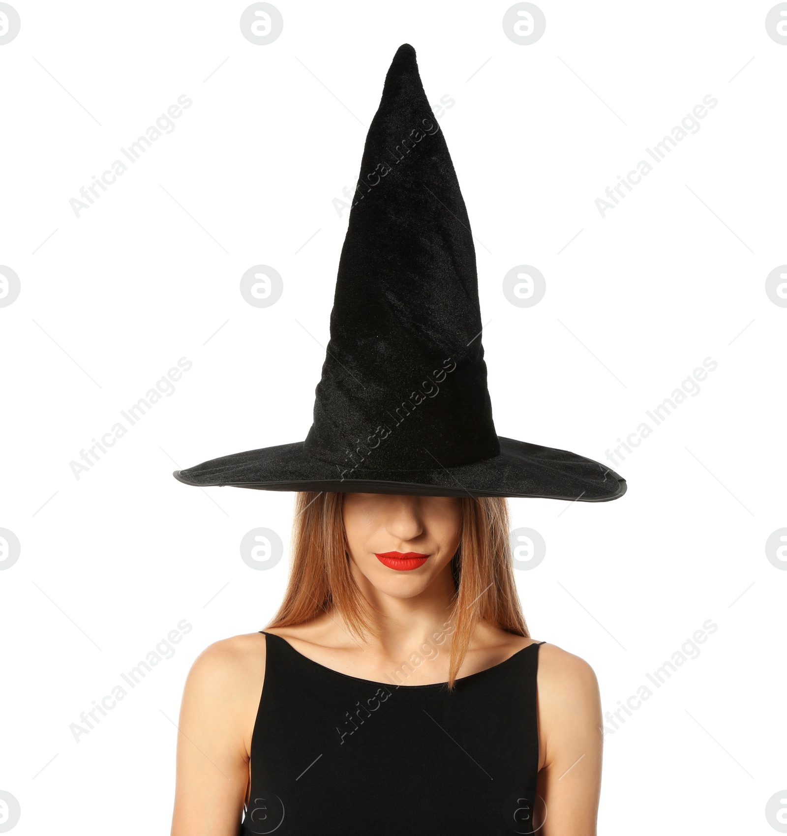 Photo of Beautiful young woman wearing witch costume for Halloween party on white background