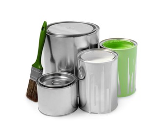 Photo of Cans of paints and brush isolated on white